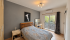 Bright Modern Bedroom with Balcony View.png