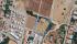 Blue-Boundary Villa Amid Fields and Homes.png